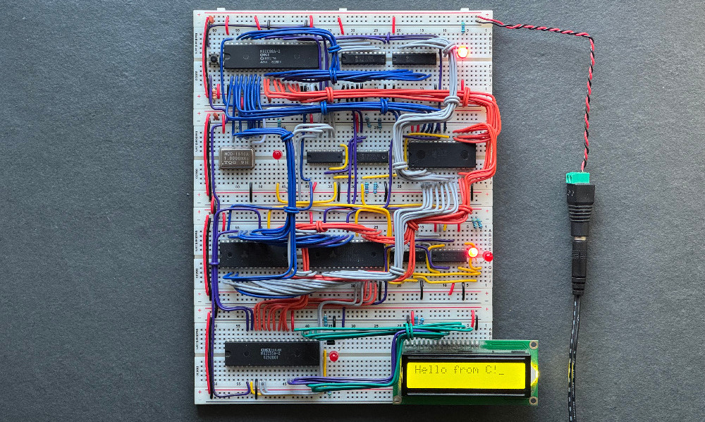 Image of computer built on breadboards displaying a hello message